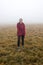 Woman on the mountains meadow in the fog