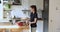 Woman moves to music while preparing vegetable salad in kitchen