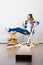 Woman moving into apartment assembly furniture.