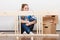 Woman moving in assembly furniture at new home.