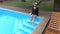 Woman mowing legs in swimming pool