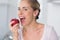 Woman munching apple