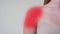 Woman muscle shoulder pain with red inflamed pulcating spot
