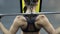 Woman with muscular shoulders doing pulldown exercise in gym, active training