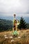 Woman with mushroom, on mountain meadow, mushroom as a umbrella.