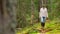 Woman with mushrooms in basket walking in forest