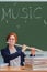 Woman music teacher plays flute in school class