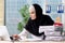 The woman muslim employee working in the office