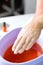 Woman in nail salon having paraffin bath