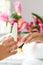 Woman in nail salon receiving manicure