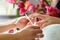 Woman in nail salon receiving manicure