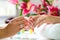 Woman in nail salon receiving manicure