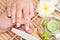 Woman in a nail salon receiving manicure