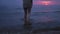 Woman naked legs close up walking water - Amazing dark scenic vivid crimson rare red sunset with violet and magenta