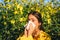 Woman with napkin fighting blossom allergie outdoor. Allergy to flowering. Young woman is going to sneeze. Sneezing and