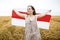 Woman with national belarus flag stand in wheat field