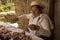 A woman in a national costume makes and sells souvenirs at the Sibambe railway station, Ecuador.