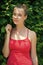 Woman with natural makeup in prague, czech republic on sunny day. Sensual woman on green fence. Girl with young look and