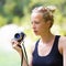 Woman in nature with retro camera.