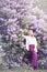 Woman near the blossoming lilac, tinted