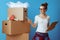 Woman near cardboard box using moving checklist and count boxes