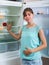 Woman near empty fridge