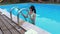 Woman near handles at swimming pool
