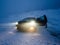 Woman near lonely parked car in snow deserted area problem with tire