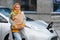 Woman near a rental electric car. Vehicle charged at the charging station