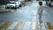 Woman with neck brace is walking on pedestrian crossing in city, curing of diseases of musculoskeletal system