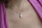 Woman neckline wearing moon stone mineral stone pendant on silver chain