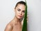 woman next to a green aloe leaf on a composite plan clean skin cosmetology natural look