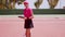 Woman with notebook and racket at tennis net