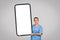 Woman nurse presenting large blank smartphone screen