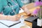 Woman nurse working with medical history writing on paper close