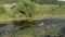 Woman with oar in hands is paddling in kayak on river. Female tourist is travelling along river in canoe. Girl traveller is explor