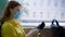Woman observes precautions in public and wears a medical mask to protect against virus and infection during a