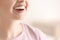 Woman with occlusal splint on light background, closeup