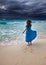 Woman on an ocean coast, storm