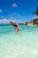 Woman in ocean waving and splashing water