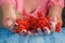 Woman offer Rowan berries on vintage wooden boards