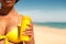 Woman offering suncream on beach