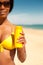 Woman offering suncream on beach