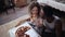 Woman offers pizza to man, but eat slice by herself. Multiracial couple having fun during the meal with fast food.