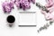 Woman office desk with frame, coffee and lilac blossom design white background top view mockup