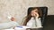 Woman in office drinking coffee resting in workplace. beautiful businesswoman with phone sits in a chair with bare feet