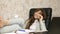 Woman in office drinking coffee resting in workplace. beautiful businesswoman with phone sits in a chair with bare feet