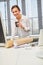 Woman in the office drinks coffee from a plastic cup