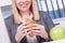 Woman at the office having lunch. Concept for healty or unhealthy food at work