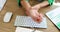 A woman in the office massages her wrist, slowmotion